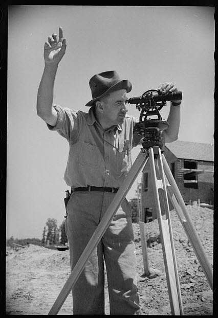 A Surveyor measuring land.