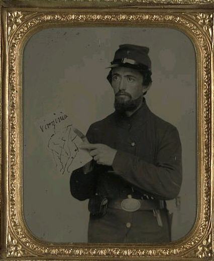 A Union soldier pointing out a location on a map of Virginia.