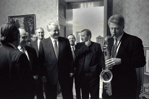 Bill Clinton playing a saxophone at a state sponsored event.