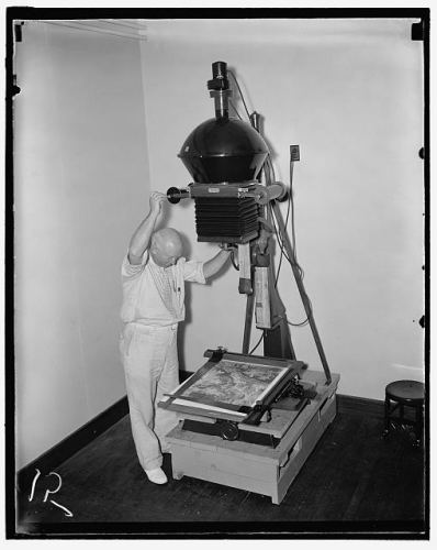 An Agricultural Adjustment Administration worker making prints for a $3,000,000 map in 1937.