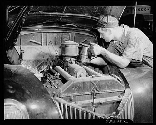 A mechanic working on a car (or auto).