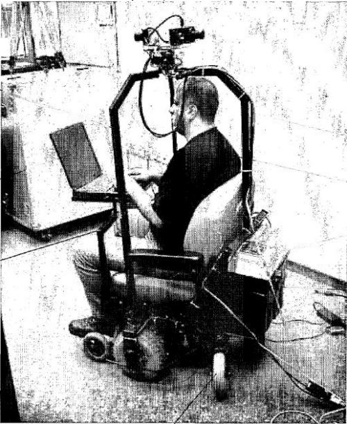 An image of someone riding a mobile camera device with cameras mounted on top and a laptop in front.