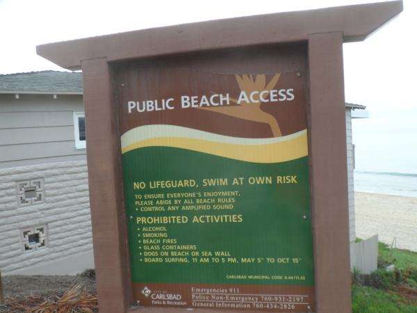 A Public Beach Access information sign provides details about nearby beaches.