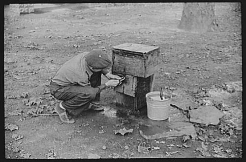 A man locking up access to water, to keep people from other camps from stealing it.